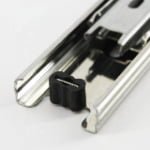 Detailed view of drawer slide bump for impact absorption and stability